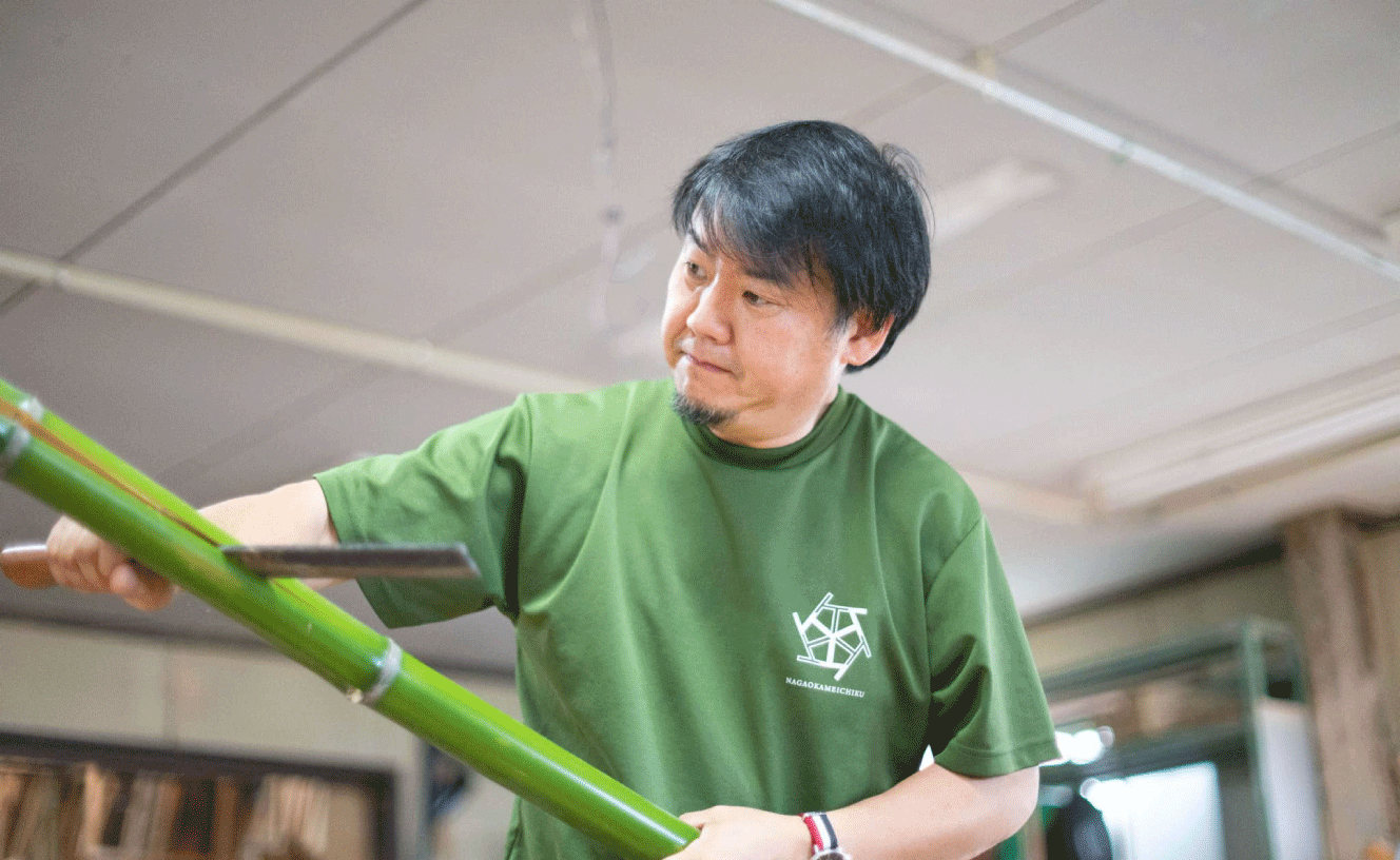 Man carving bamboo in workshop